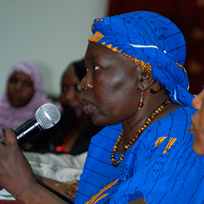 A woman speaking at a public meeting