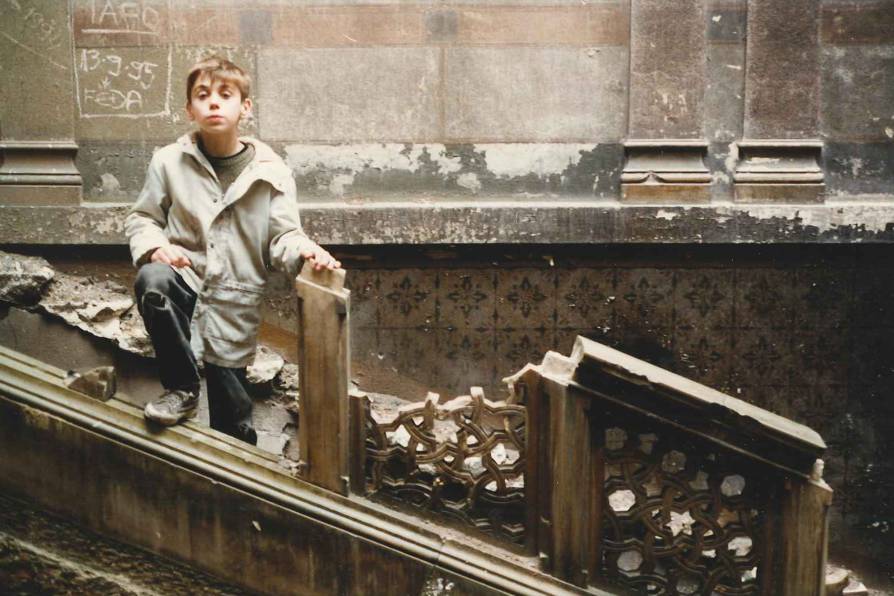 A boy posed among ruins from more prosperous times. A generation of Bosnians was exposed to wartime disruption and death.