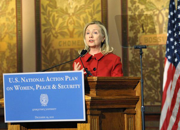 clintongeorgetown_620 Sec. Clinton giving a speech from behind a podium. Sign on the podium says "US National Aciton Plan on Women, Peace, and Security