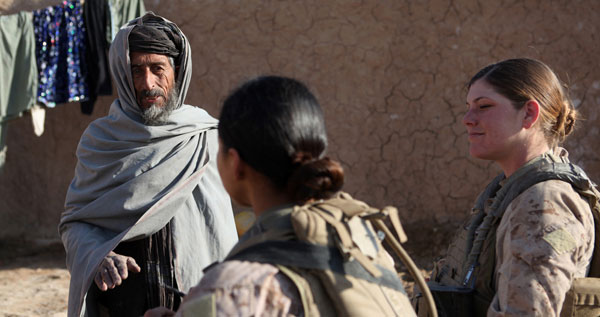 Women-in-combat-get-the-job-done Two female military troops speak with a man in Afghanistan